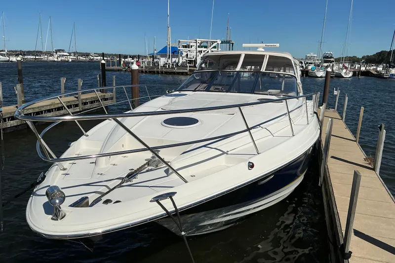 Slide: The Image of 2003 Regal Commodore 4260 yacht docked at marina, showcasing sleek design and spacious deck. - 12