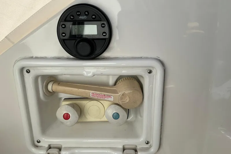 Slide: The Image of 2003 Regal Commodore 4260 boat shower controls and audio system panel. - 15