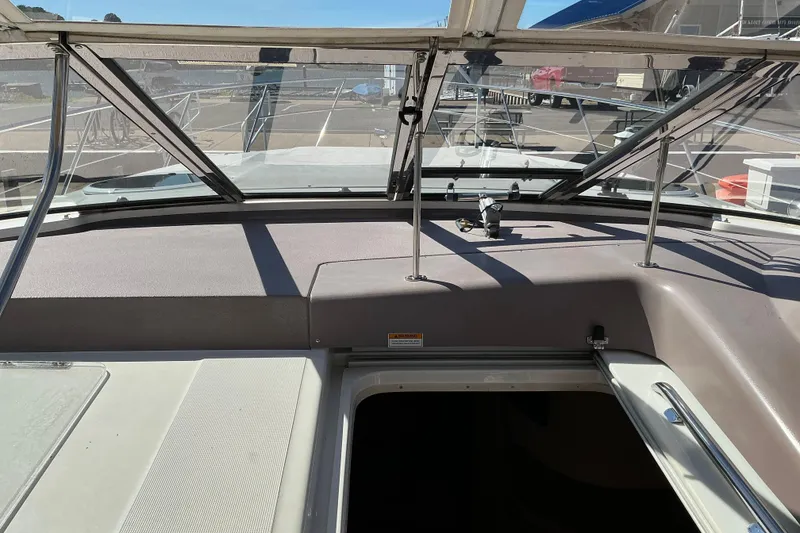 Slide: The Image of 2003 Regal Commodore 4260 boat interior with open hatch and windshield view. - 16