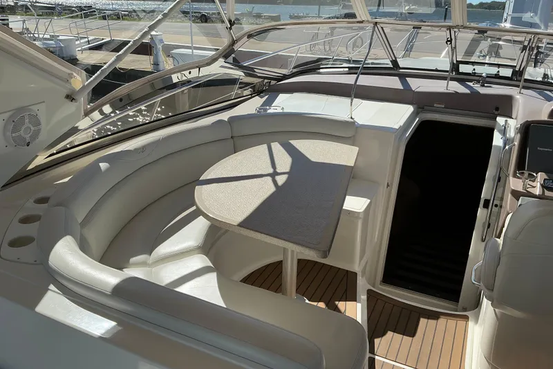 Slide: The Image of 2003 Regal Commodore 4260 yacht interior with seating and table, docked at marina. - 18