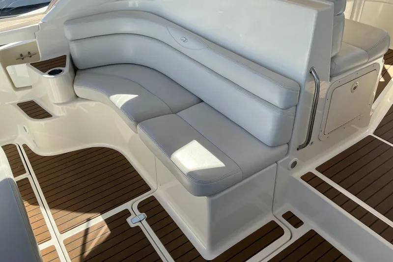 Slide: The Image of 2003 Regal Commodore 4260 boat interior with white seating and wood flooring. - 19
