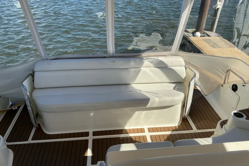 Slide: The Image of 2003 Regal Commodore 4260 boat interior with white seating and wooden flooring. - 20