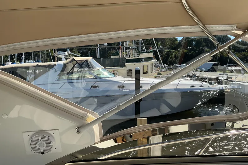 Slide: The Image of 2003 Regal Commodore 4260 yacht docked at marina, viewed from another boat. - 23