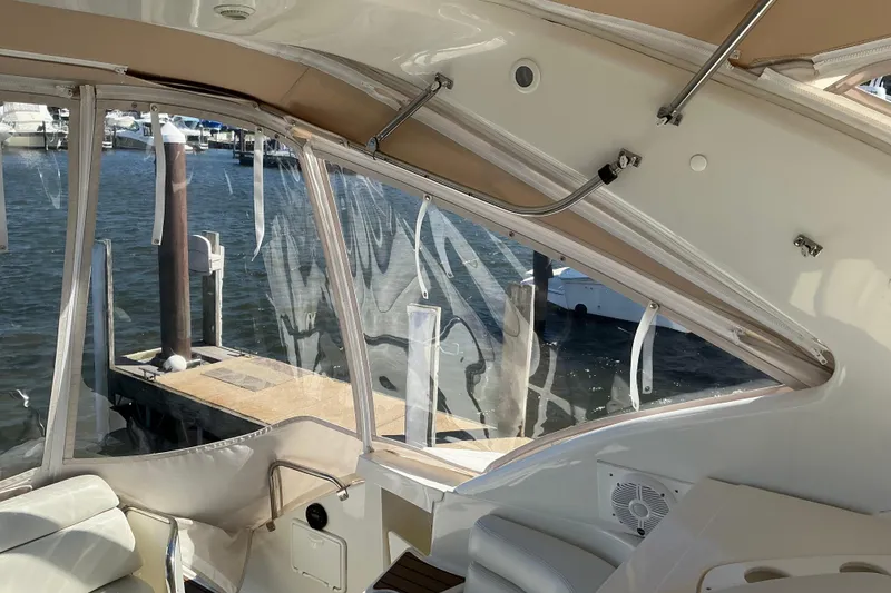 Slide: The Image of Interior view of 2003 Regal Commodore 4260 yacht with marina backdrop. - 24