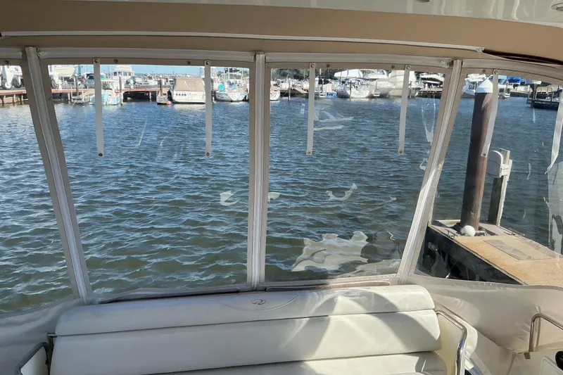 Slide: The Image of Interior view from a 2003 Regal Commodore 4260 yacht overlooking a marina. - 25