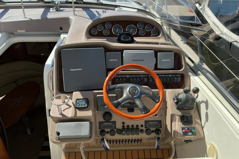 Slide: The Image of 2003 Regal Commodore 4260 yacht helm with Raymarine and Garmin navigation systems. - 31