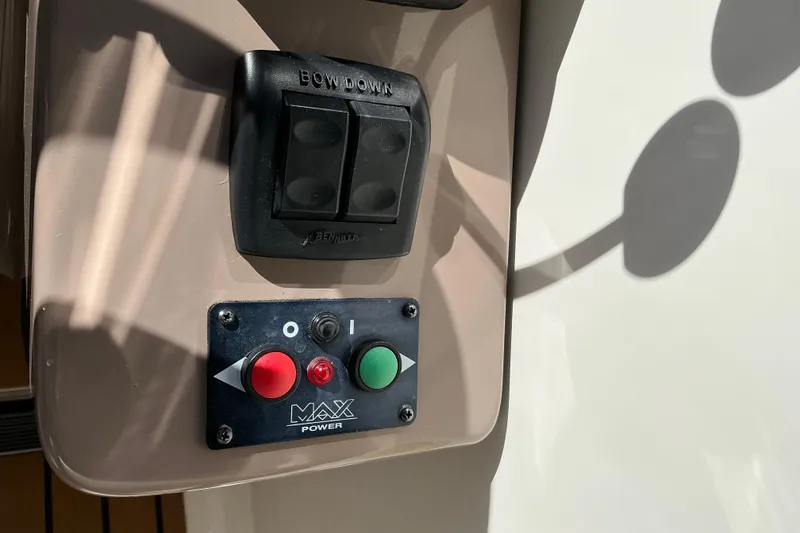 Slide: The Image of Control panel on a 2003 Regal Commodore 4260 boat, featuring buttons and switches. - 35