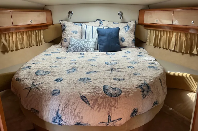 Slide: The Image of Luxurious 2003 Regal Commodore 4260 yacht bedroom with nautical-themed bedding. - 38