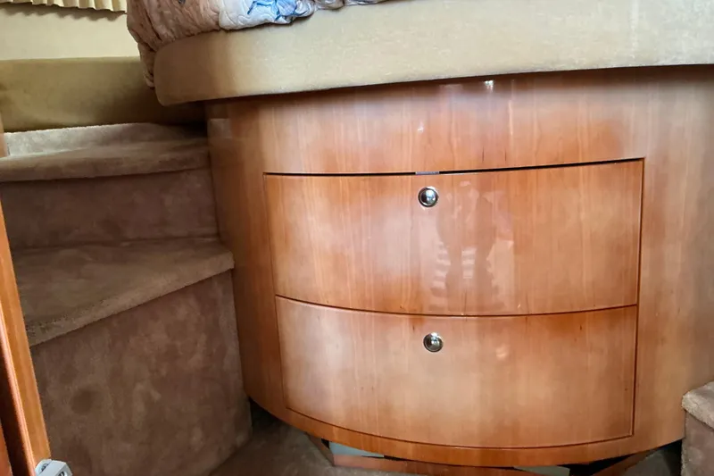 Slide: The Image of 2003 Regal Commodore 4260 interior with wooden drawers and carpeted steps. - 45