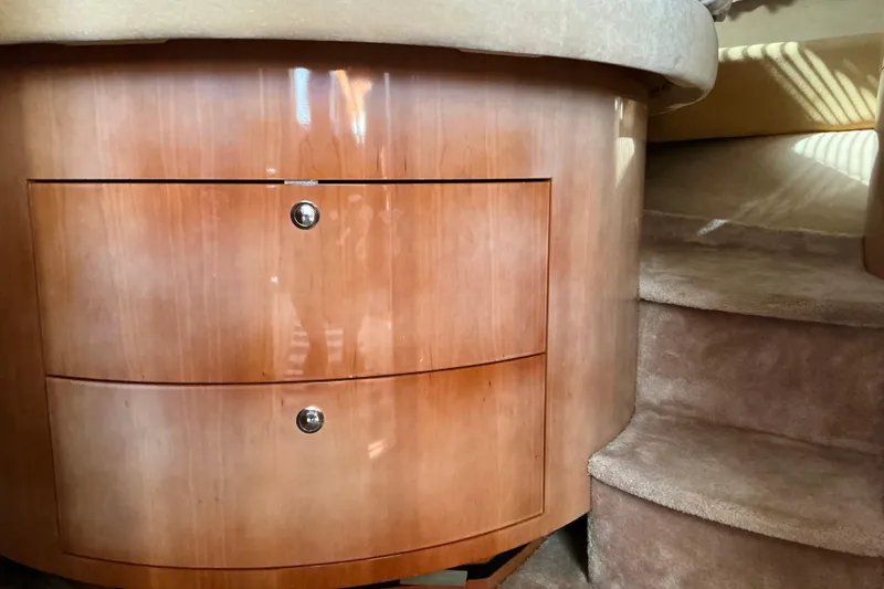 Slide: The Image of 2003 Regal Commodore 4260 interior with wooden drawers and carpeted stairs. - 46