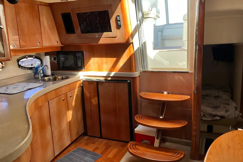 Slide: The Image of Luxurious 2003 Regal Commodore 4260 yacht interior with wooden cabinetry and modern amenities. - 51