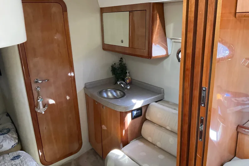 Slide: The Image of 2003 Regal Commodore 4260 yacht interior with wooden cabinetry and compact sink area. - 52