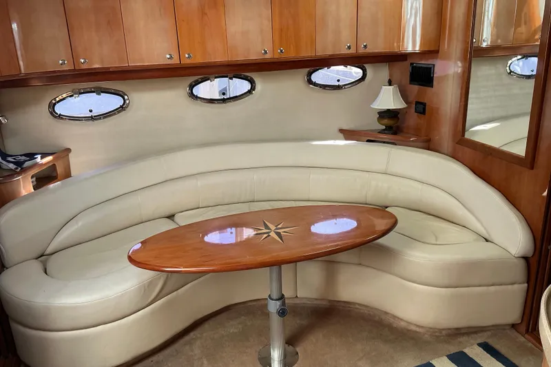 Slide: The Image of Luxurious interior of 2003 Regal Commodore 4260 yacht with curved seating and elegant table. - 56