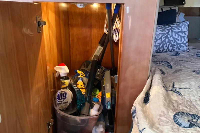 Slide: The Image of Cabinet in 2003 Regal Commodore 4260 yacht with cleaning supplies and tools. - 58