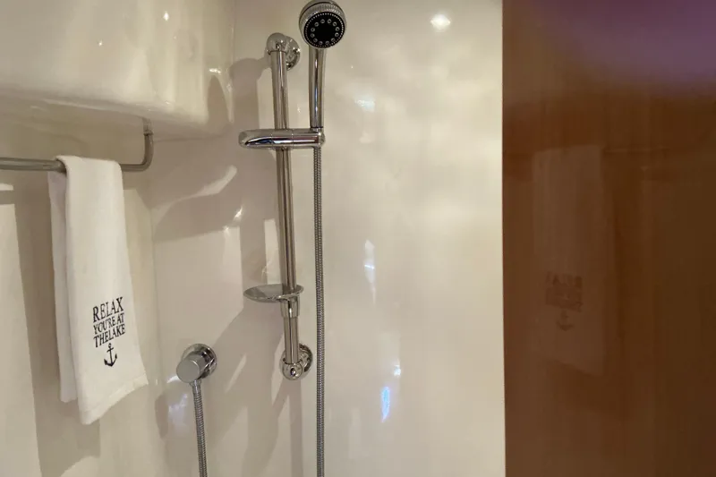 Slide: The Image of Shower area in 2003 Regal Commodore 4260 yacht with towel reading "Relax, You're at the Lake." - 60