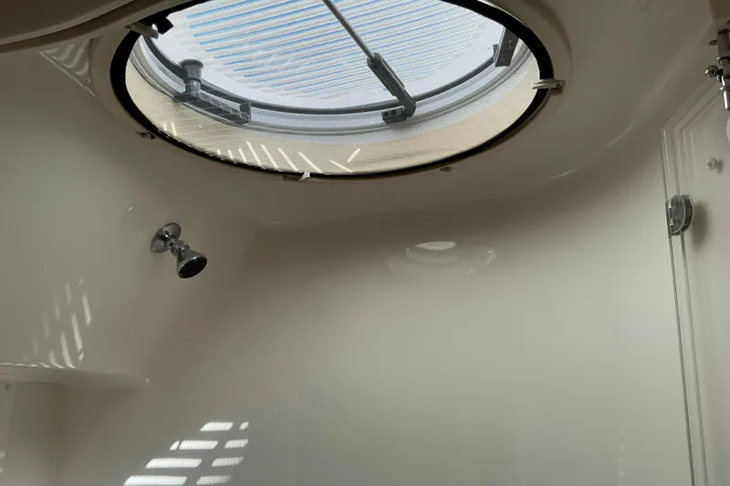 Slide: The Image of Interior of 2003 Regal Commodore 4260 boat with circular skylight and showerhead. - 66