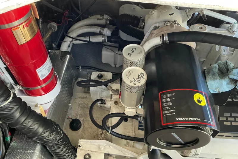 Slide: The Image of Engine room of 2003 Regal Commodore 4260 with Volvo Penta components and fire extinguisher. - 74