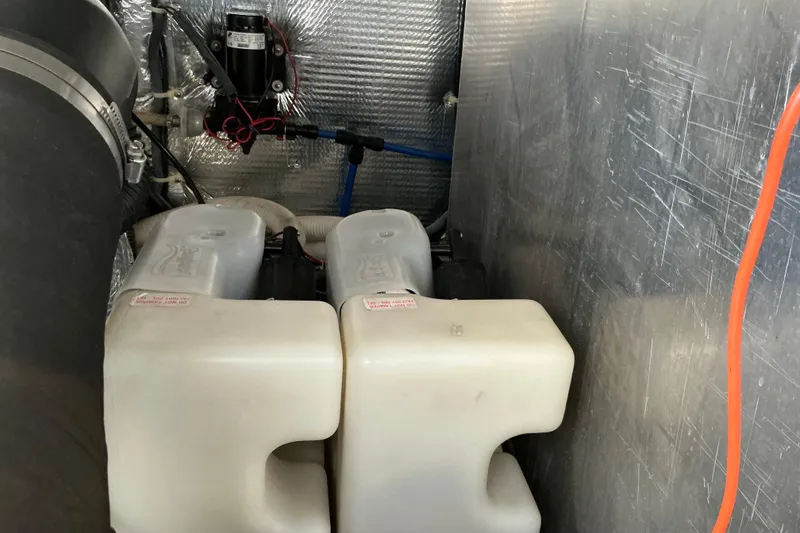 Slide: The Image of Engine compartment of 2003 Regal Commodore 4260 with water tanks and wiring. - 76