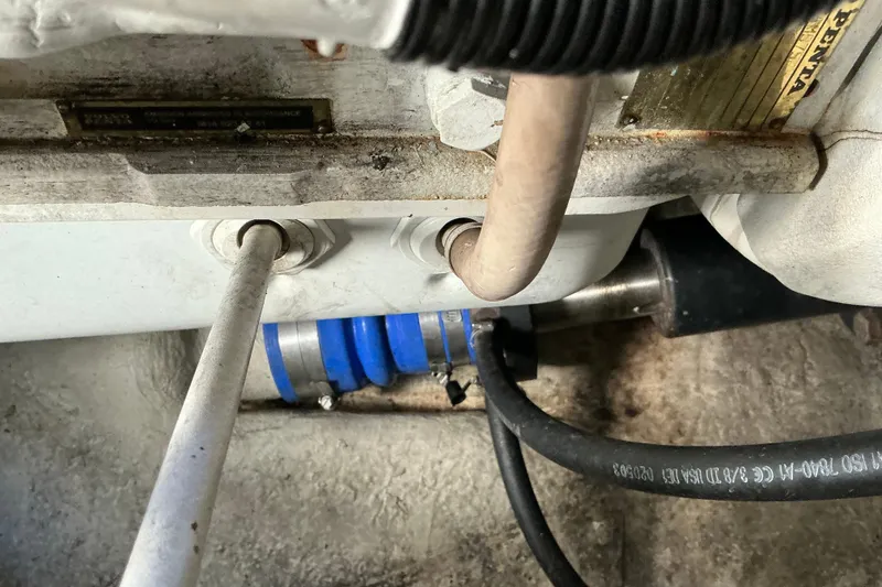 Slide: The Image of Engine compartment of a 2003 Regal Commodore 4260 boat, showing pipes and hoses. - 82