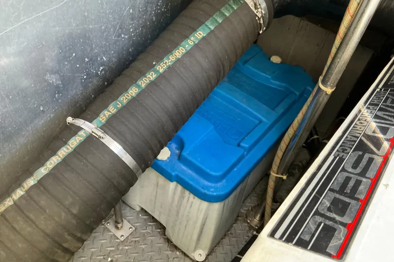 Slide: The Image of 2003 Regal Commodore 4260 engine compartment with blue battery and exhaust hose. - 88