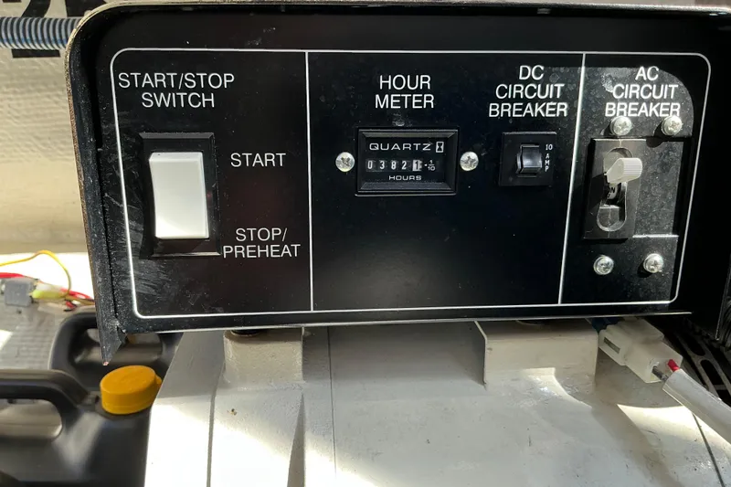 Slide: The Image of Control panel of a 2003 Regal Commodore 4260 with start switch and circuit breakers. - 90