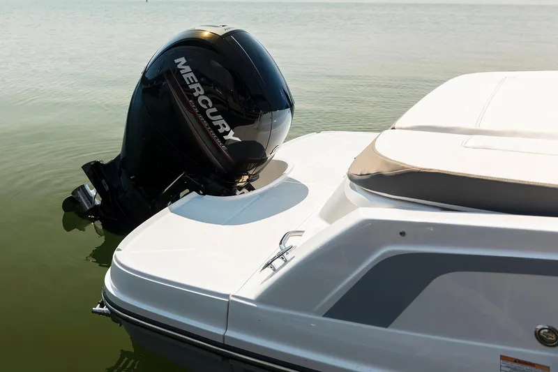 Slide: The Image of 2023 Bayliner VR5 Bowrider OB on trailer, parked near blue building. - 4