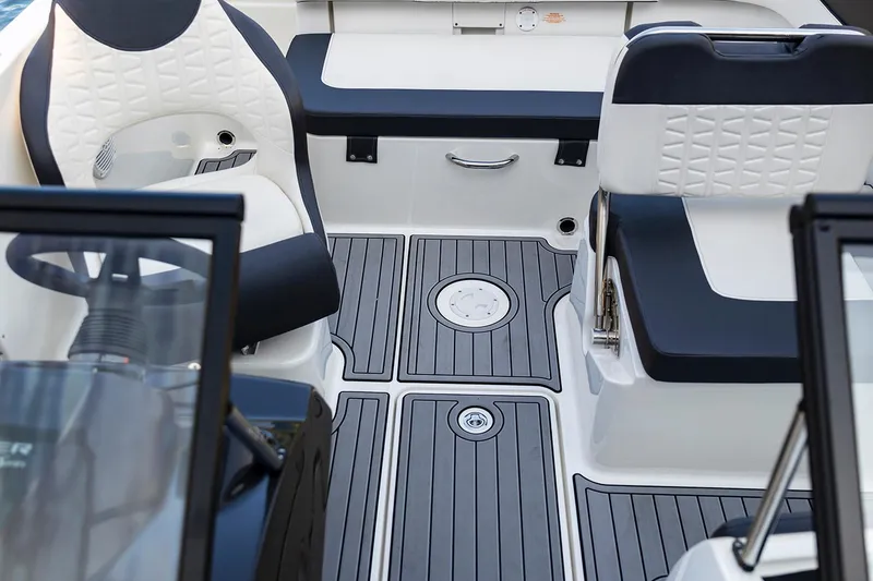 Slide: The Image of 2023 Bayliner VR5 Bowrider OB with outboard motor, parked outdoors on a sunny day. - 9