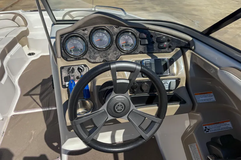 Slide: The Image of 2013 Yamaha Boats SX240 HO dashboard with steering wheel and gauges. - 11