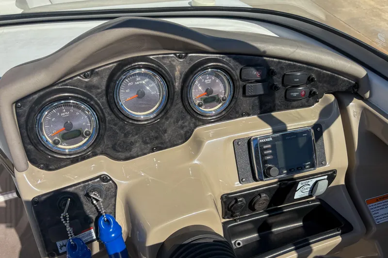 Slide: The Image of 2013 Yamaha SX240 HO boat dashboard with gauges and controls. - 12
