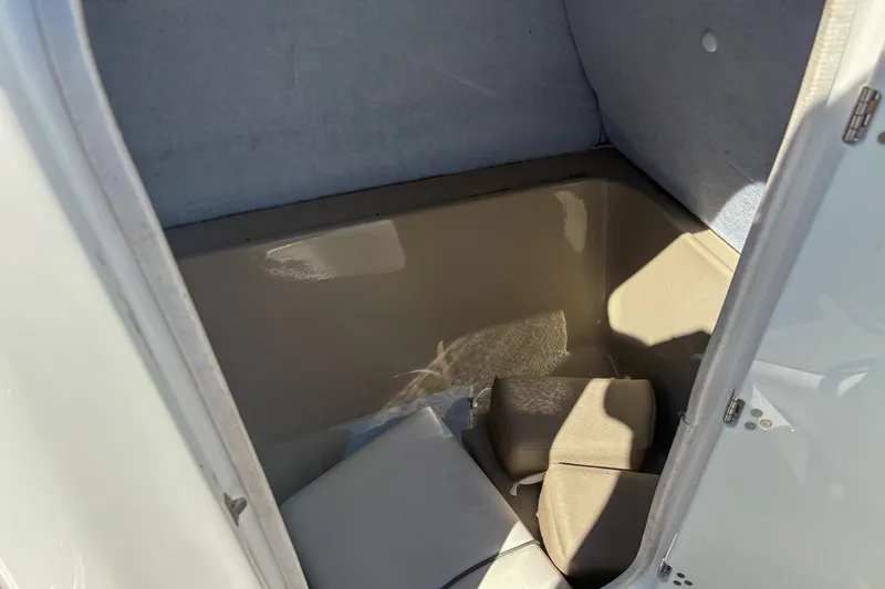 Slide: The Image of Storage compartment of a 2013 Yamaha SX240 HO boat, showing interior space and cushions. - 14