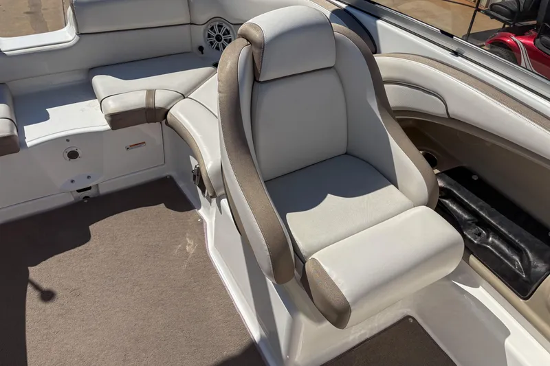 Slide: The Image of 2013 Yamaha Boats SX240 HO interior seating with beige upholstery and speaker. - 7