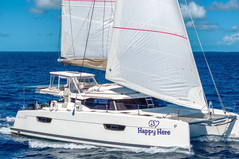 The Image of 2020 Fountaine Pajot Saona 47 catamaran sailing on open ocean under clear skies. - 0