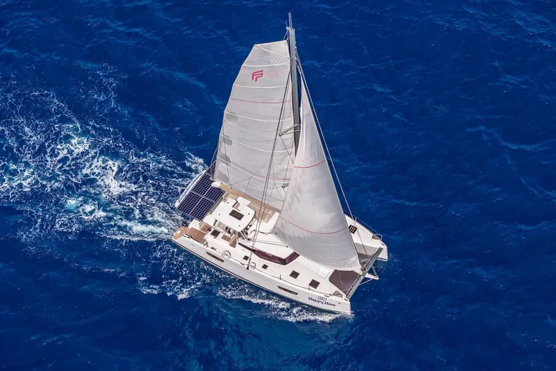 Slide: The Image of 2020 Fountaine Pajot Saona 47 catamaran sailing on vibrant blue ocean waters. - 13