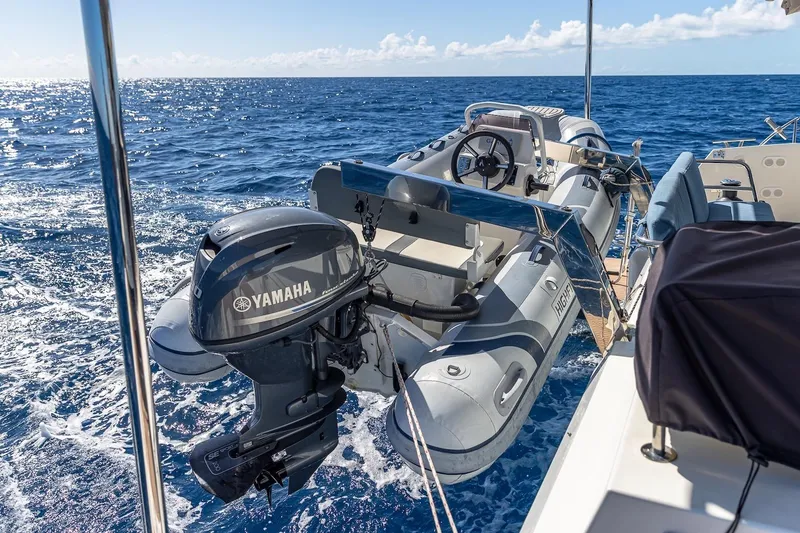 Slide: The Image of Fountaine Pajot Saona 47 yacht with Yamaha motor and inflatable boat on open sea, 2020 model. - 26