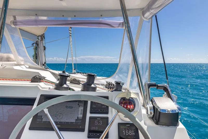 Slide: The Image of Cockpit view of 2020 Fountaine Pajot Saona 47 sailing on clear blue ocean. - 30