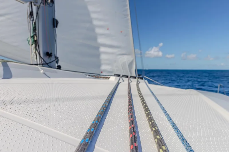 Slide: The Image of 2020 Fountaine Pajot Saona 47 catamaran sailing on open sea with clear blue sky. - 36