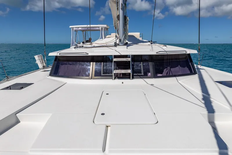 Slide: The Image of 2020 Fountaine Pajot Saona 47 catamaran on open sea under clear blue sky. - 40