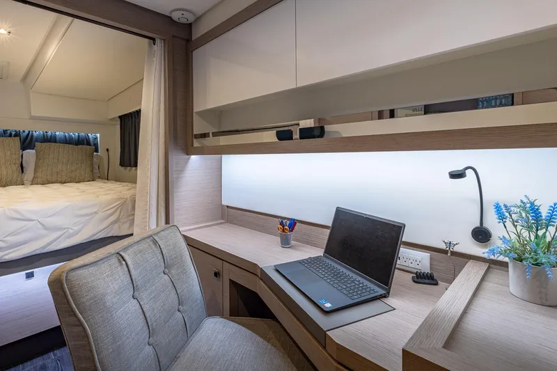 Slide: The Image of Modern workspace on 2020 Fountaine Pajot Saona 47 yacht with laptop and cozy bedroom. - 56