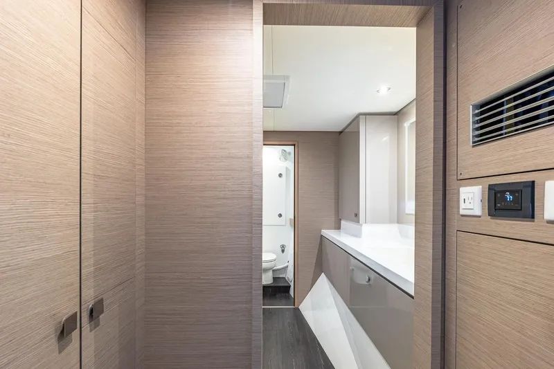 Slide: The Image of Modern bathroom interior on 2020 Fountaine Pajot Saona 47 yacht, featuring sleek wood paneling. - 60