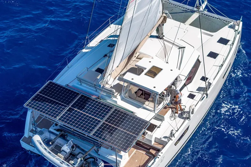 Slide: The Image of 2020 Fountaine Pajot Saona 47 catamaran sailing on blue ocean with solar panels. - 78