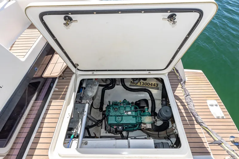 Slide: The Image of Engine compartment of 2020 Fountaine Pajot Saona 47 catamaran, open hatch, docked on water. - 81