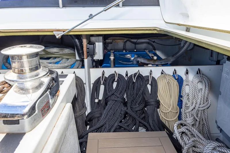 Slide: The Image of Storage compartment of 2020 Fountaine Pajot Saona 47 with neatly organized ropes and winch. - 88