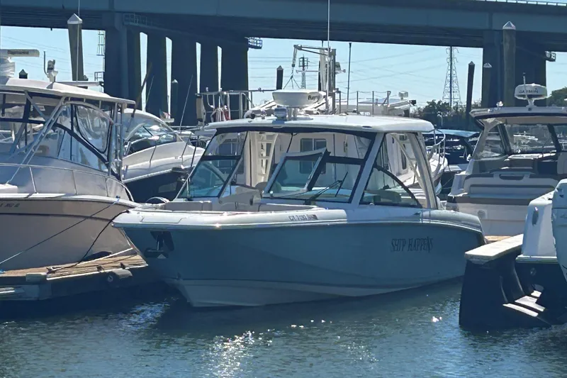 The Image of 2018 Boston Whaler 320 Vantage docked at marina under bridge. - 0