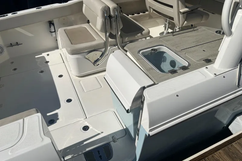 Slide: The Image of 2018 Boston Whaler 320 Vantage boat interior with seating and storage compartments. - 11