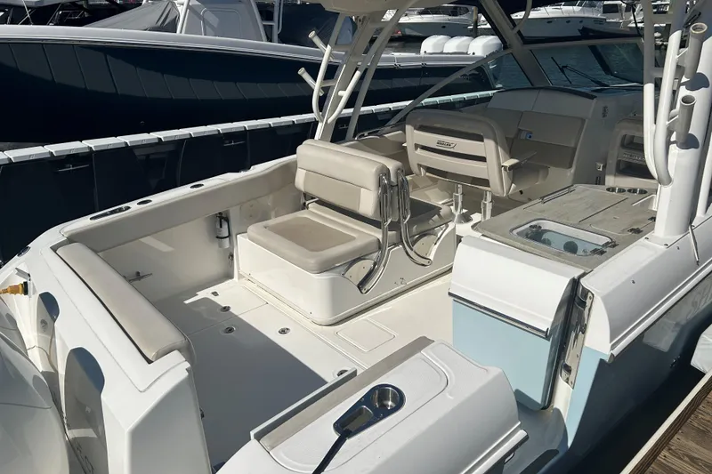 Slide: The Image of 2018 Boston Whaler 320 Vantage boat interior with seating and fishing amenities. - 12