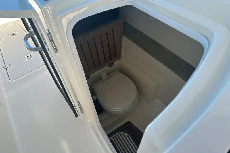 Slide: The Image of 2018 Boston Whaler 320 Vantage boat interior with compact marine toilet. - 20