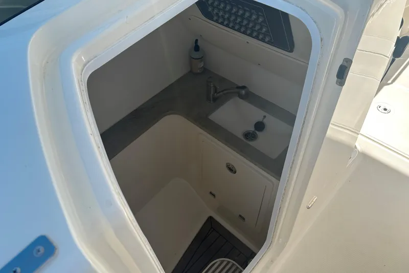 Slide: The Image of Interior view of 2018 Boston Whaler 320 Vantage boat's compact sink area. - 21