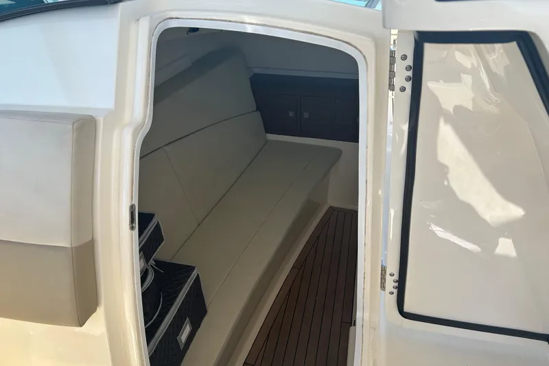 Slide: The Image of Interior cabin of 2018 Boston Whaler 320 Vantage boat, featuring seating and storage. - 22