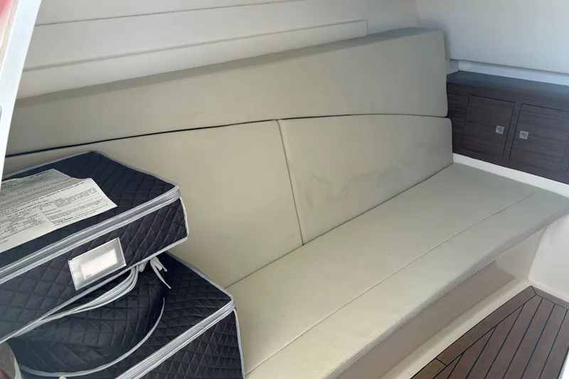 Slide: The Image of Interior of 2018 Boston Whaler 320 Vantage with cushioned seating and storage. - 24