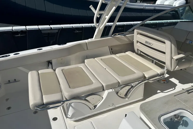 Slide: The Image of 2018 Boston Whaler 320 Vantage boat interior with cushioned seating and sleek design. - 26